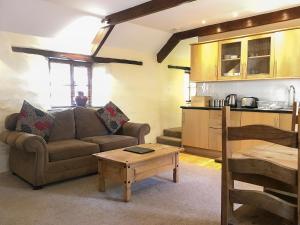 a living room with a couch and a table at Porth Cottage- W40885 in Perranporth