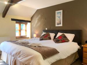 a bedroom with a large white bed with two pillows at Porth Cottage- W40885 in Perranporth