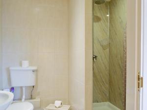 a bathroom with a shower and a toilet and a sink at The Forge-W42942 in Burn