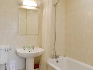 a bathroom with a sink and a toilet and a tub at The Forge-W42942 in Burn
