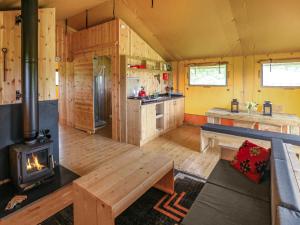 a large kitchen with a wood stove in a room at Swallow - Safari Tent - Ukc8985 in Romsey