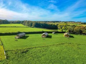 an aerial view of a large green field with tents at Swallow - Safari Tent - Ukc8985 in Romsey