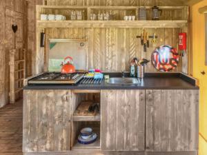 a kitchen with a sink and a stove at Swallow - Safari Tent - Ukc8985 in Romsey +9 photos
