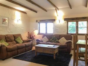 a living room with two couches and a coffee table at Crantock Cottage- W40888 in Perranporth