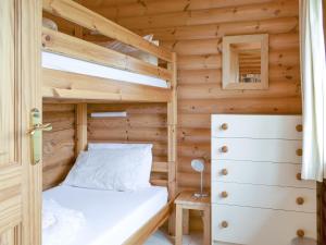 a bedroom with a bunk bed in a wooden cabin at Mallard Lodge - W43171 in Burn +8 photos