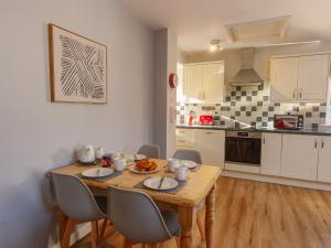 a kitchen with a wooden table and chairs in a room at Number Four - Ukc4966 in Tawstock