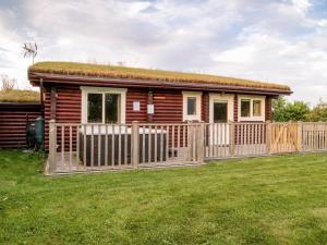 a log cabin with a grass roof at Partridge Lodge-W43008 in Burn +7 photos