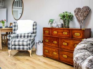a bedroom with a dresser and a chair at Buck Barn - Ukc8185 in Dolau