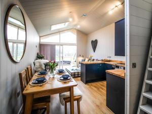 a kitchen and dining room with a table and chairs at Buck Barn - Ukc8185 in Dolau