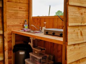 a kitchen with a counter and a sink in a cabin at Cornflower- Ukc4941 in West Anstey +19 photos