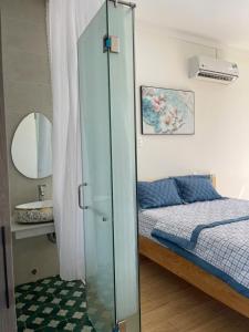 a bedroom with a bed and a glass closet at BM homestay in Buôn Dhă Prŏng +1 photo