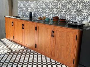 a kitchen with a counter with bowls and plates on it at BM homestay in Buôn Dhă Prŏng