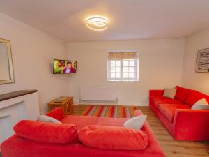 a living room with red furniture and a red couch at Number Five - Ukc4967 in Tawstock