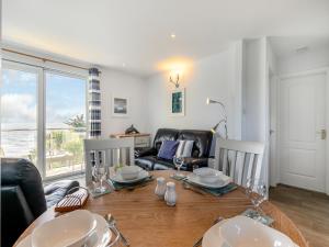 a dining room with a table with a view of the ocean at 10 Mount Brioni in Downderry