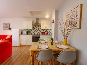 a kitchen with a wooden table and chairs in a room at Number Five - Ukc4967 in Tawstock