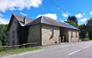 an old brick building on the side of a road at Loft Apartment at Moulin SAGE in Treignac