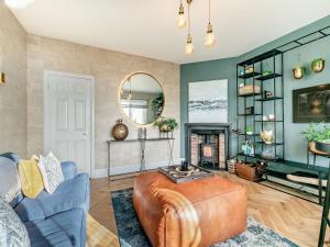 a living room with a couch and a fireplace at 17 Mount Brioni in Downderry