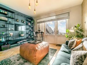 a living room with a couch and a table at 17 Mount Brioni in Downderry