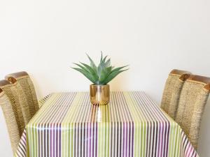 a table with a plant in a vase on it at Langetot in Bury Saint Edmunds