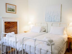 two beds sitting next to each other in a bedroom at Langetot in Bury Saint Edmunds +6 photos