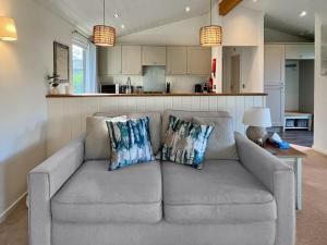 a living room with a couch and a kitchen at The Ardle in Crieff