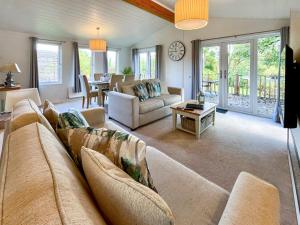 a living room with a couch and a table at The Ardle in Crieff +16 photos