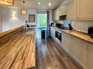 a kitchen with a wooden counter top and a sink at The Ardle in Crieff
