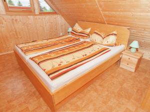 uma cama num quarto de madeira com uma cama sidx sidx em Holiday home with private terrace in Gehren em Altenfeld