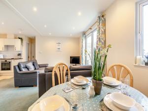 a living room with a table and a couch at 11 Mount Brioni - Ukc5345 in Torpoint