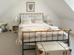 a bedroom with a bed and two night stands at Culrain Cottage in Fort Augustus +8 photos