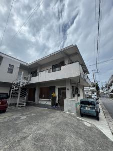 a car parked in front of a building at YADOKARI miyakojima in Miyako-jima