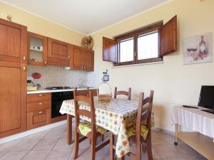 a kitchen with a table and chairs and a kitchen with a stove at Exquisite Farmhouse in Casperia with Pool in Casperia