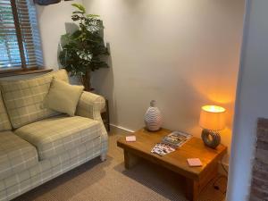 a living room with a couch and a coffee table at Victory Cottage in Cottesmore
