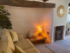 a living room with a couch and a table at Victory Cottage in Cottesmore