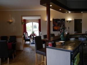 a kitchen and living room with a table and chairs at Hotel Eigen in Halle an der Saale
