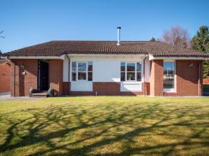 a brick house with a lawn in front of it at Eagle 3 Star - Ukc5056 in Aviemore