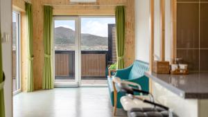 a kitchen with a chair and a counter with a view at Buan Cordelia Pool Villa Pension in Buan
