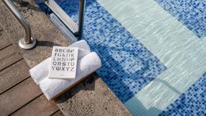 a towel sitting next to a swimming pool at Buan Cordelia Pool Villa Pension in Buan