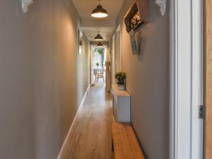 a hallway with a wooden floor and a wooden bench at Avocet - Ukc5446 in Pakefield