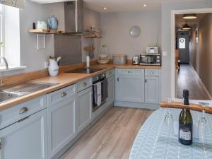 a kitchen with white cabinets and a sink at Avocet - Ukc5446 in Pakefield +11 photos