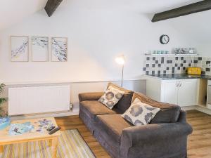 a living room with a couch and a table at Number Two - Ukc4964 in Tawstock