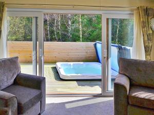 a living room with a jacuzzi tub on a patio at Jessie's Corner - Ukc5509 in West Thirston