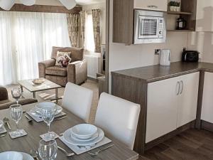 a kitchen and a living room with a table and chairs at Jessie's Corner - Ukc5509 in West Thirston