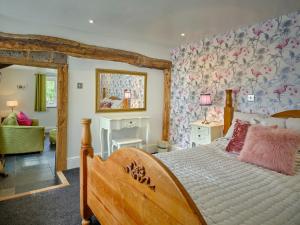 a bedroom with a large bed with a floral wall at The Den - Ukc4937 in West Anstey