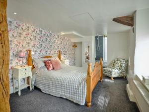 a bedroom with a bed and a chair at The Den - Ukc4937 in West Anstey