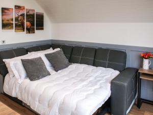 a large bed with white sheets and pillows in a room at Knockan - Ukc6026 in Newmill +4 photos