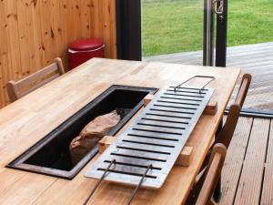 a wooden table with a grate on top of it at Knockan - Ukc6026 in Newmill