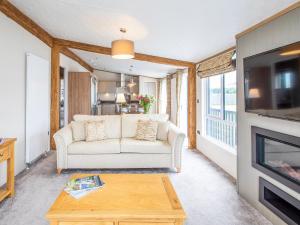 a living room with a couch and a tv at Rivendale 7 in St. Andrews +16 photos