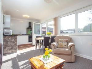 a living room with a chair and a table at 310 The Cove - Ukc5025 in Dawlish