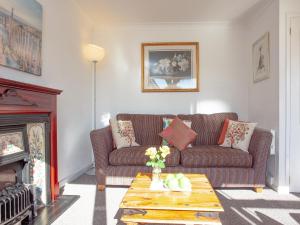 a living room with a couch and a fireplace at 310 The Cove - Ukc5025 in Dawlish